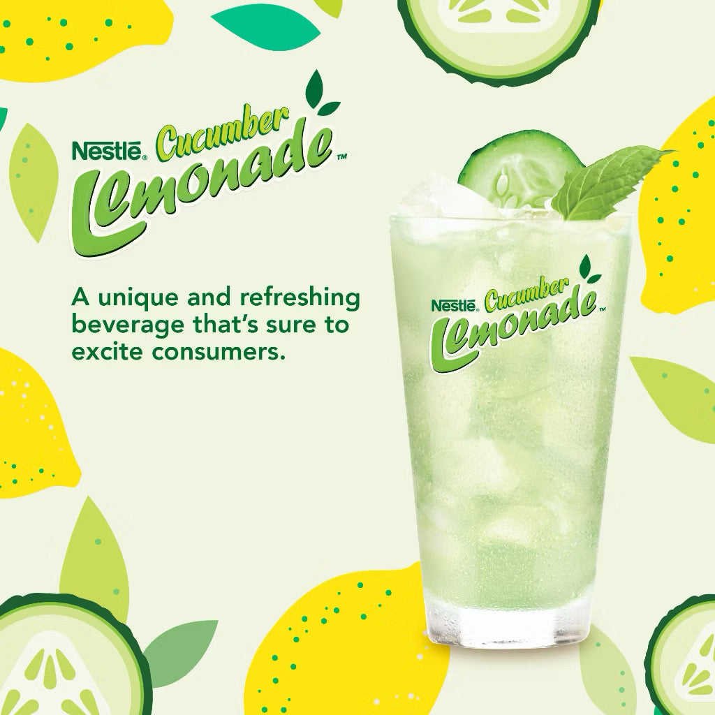Nestle Cucumber Lemonade with a glass of lemonade, lemons, and cucumbers on a light green background.